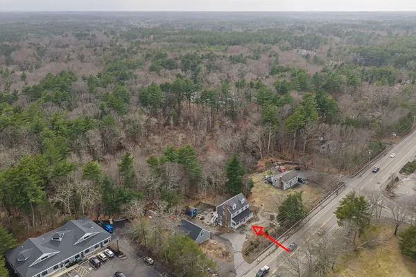 an aerial view of a house with a yard