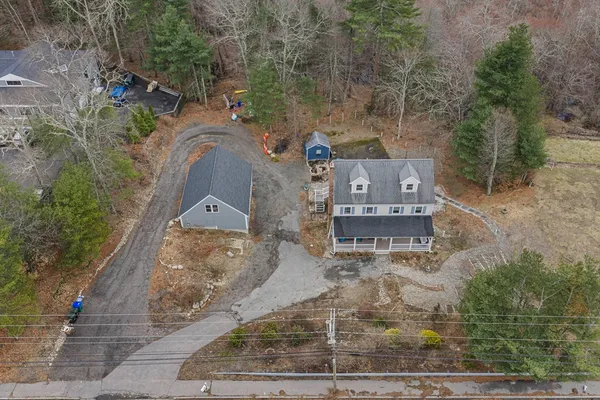 an aerial view of a house with a yard