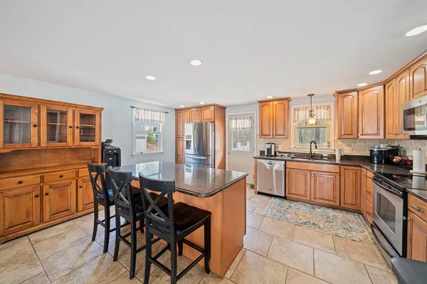 a large kitchen with a table and chairs