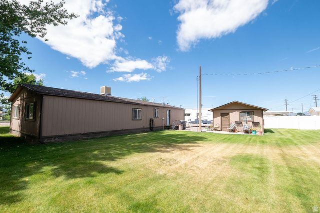 855 East 300 N Street Beaver, UT 84713 - Photo 8 of 44 Expansive green lawn surrounds a single-story structure with tan siding and a dark roof
