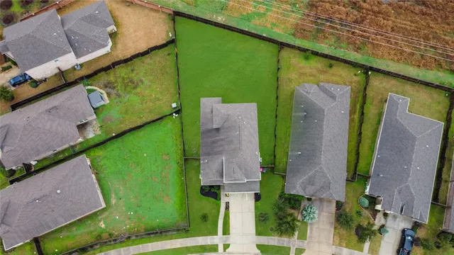 an aerial view of a house with a garden and plants