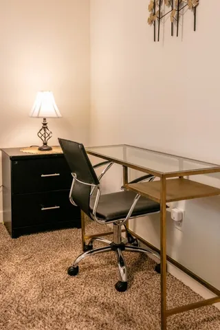 a bedroom with a bed and a flat tv screen on a dresser