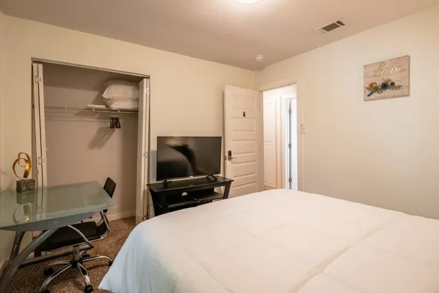 a view of a dining room with furniture and a mirror