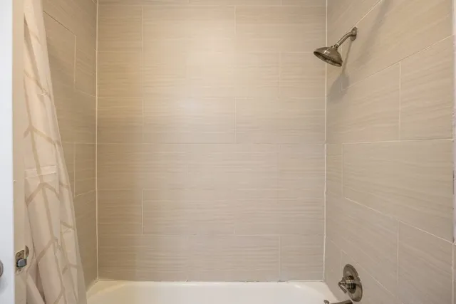 a living room with furniture a fireplace and next to a window