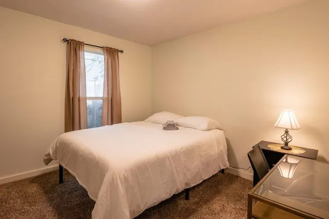 a bedroom with a bed and a window