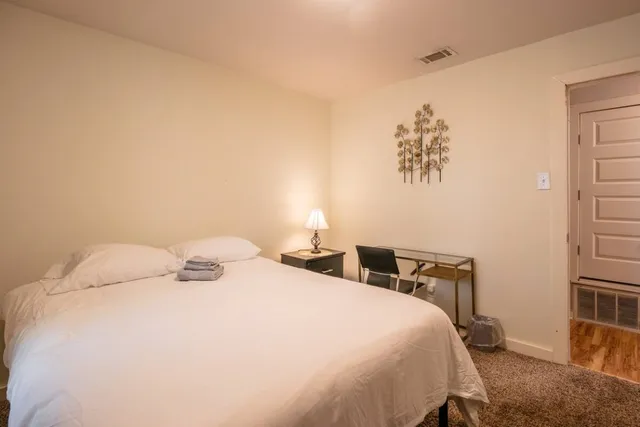 a bedroom with a bed and a window