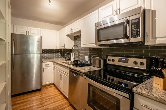 a kitchen with a stove microwave and refrigerator