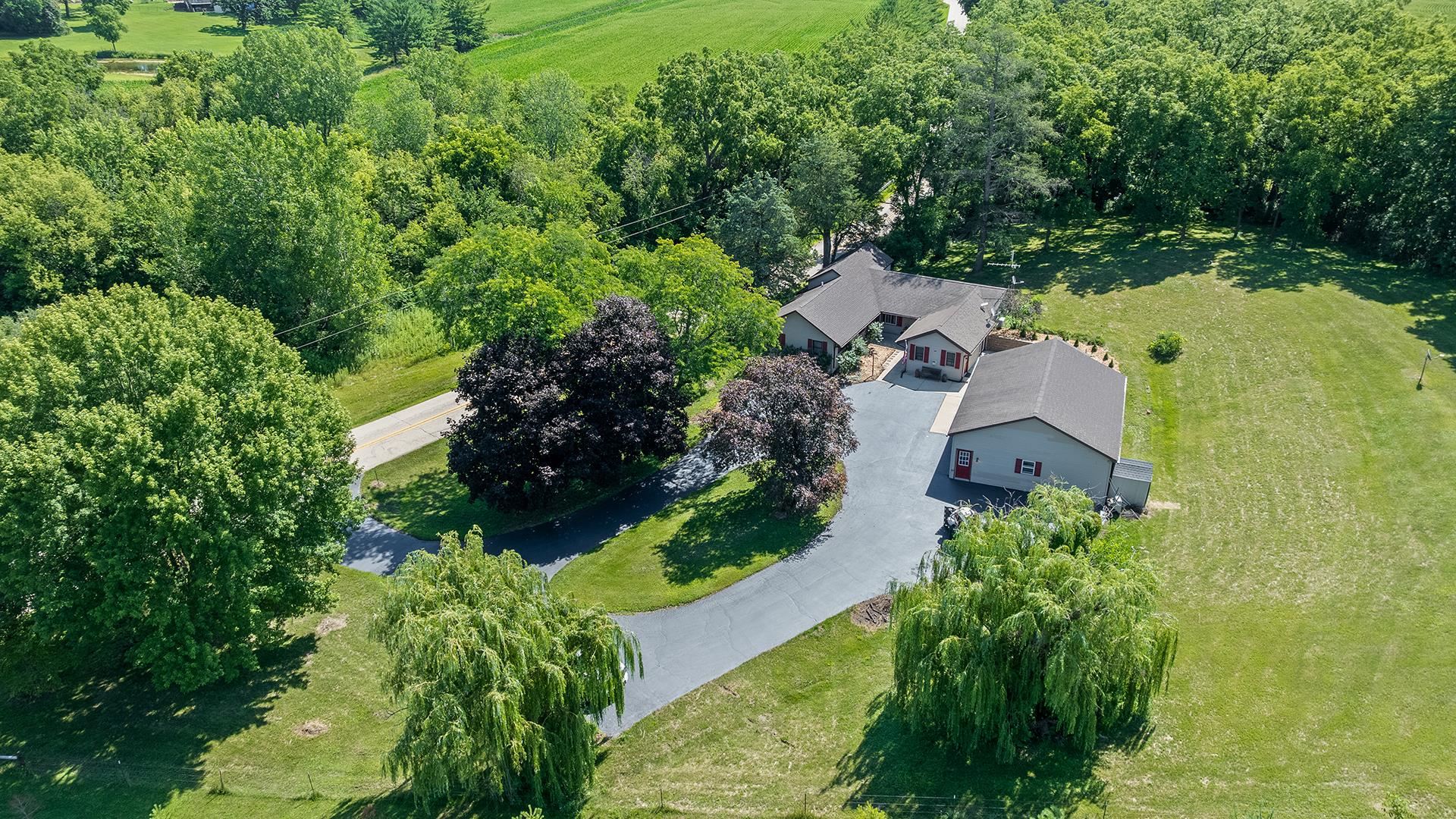 an aerial view of a house with a yard