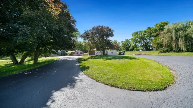 a living room with furniture a wooden floor and a chandelier