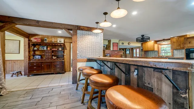 a kitchen with stainless steel appliances granite countertop a stove and a wooden floors