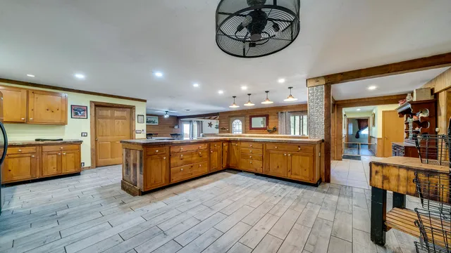 a kitchen with stainless steel appliances kitchen island granite countertop a table and chairs in it