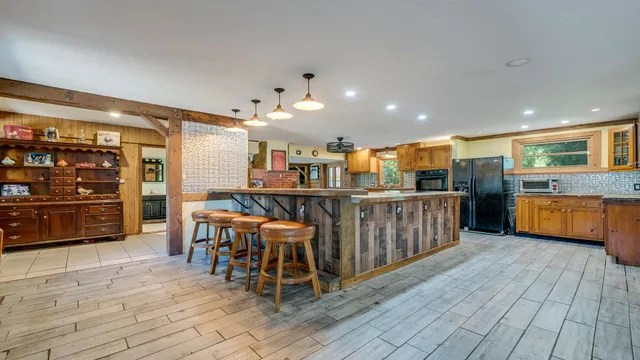 a spacious bathroom with a granite countertop sink a mirror and shower