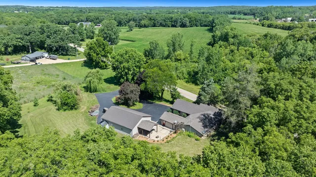 an aerial view of a house with a yard