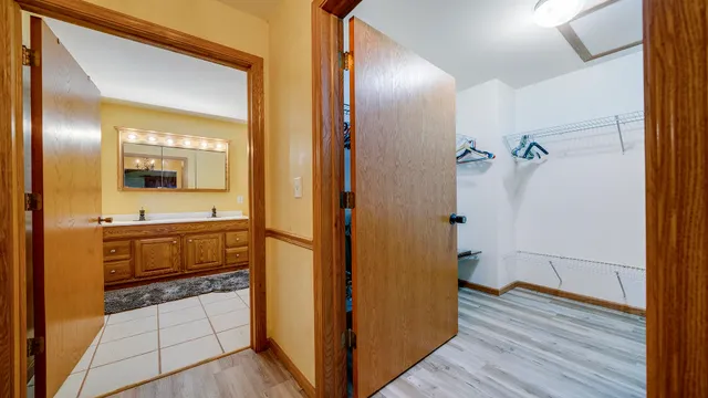 a spacious bathroom with a granite countertop sink a mirror and a shower