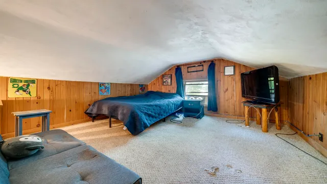 a bedroom with a bed and a couch