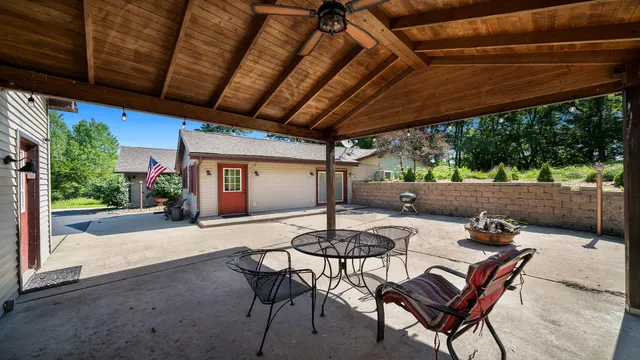 a patio with a patio table and chairs