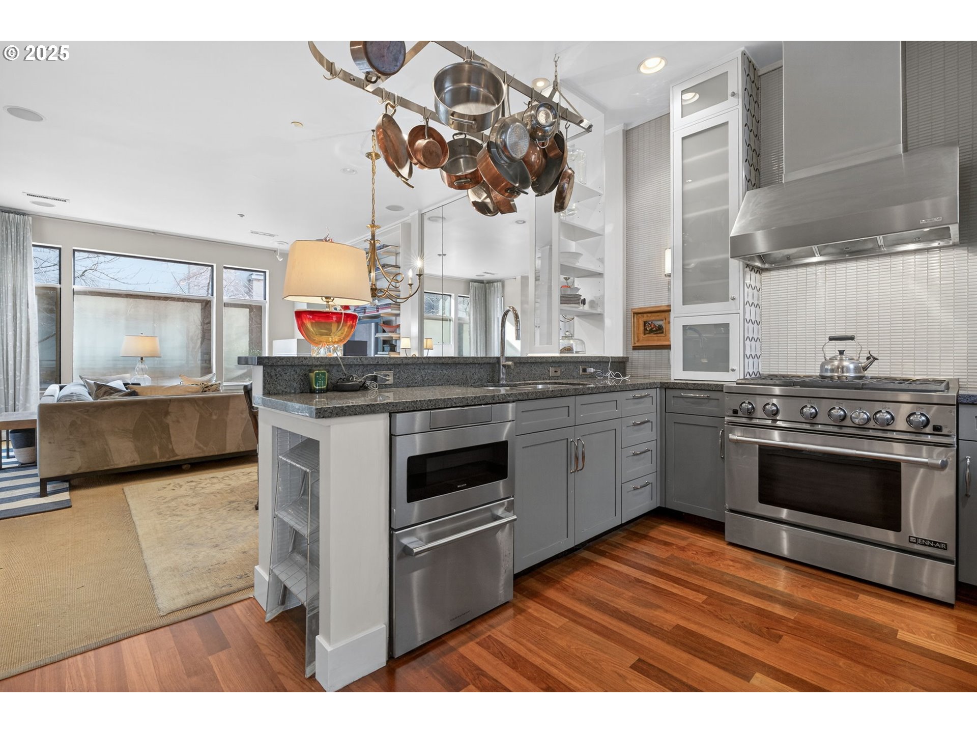 2018 Northwest 16th Avenue Portland, OR 97209 - Photo 8 of 48 a kitchen with stainless steel appliances granite countertop a stove a sink and a microwave