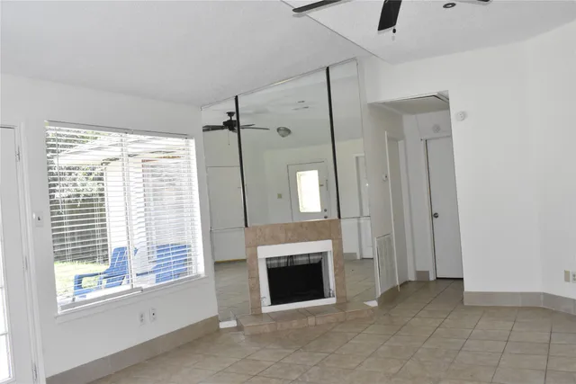 a view of a livingroom with a fireplace and window