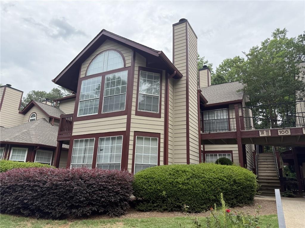 105 Hawkstone Way Alpharetta, GA 30022 - Photo 1 of 23 a view of a big house with large windows and a yard
