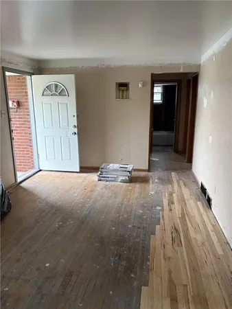 a view of a livingroom with wooden floor and window