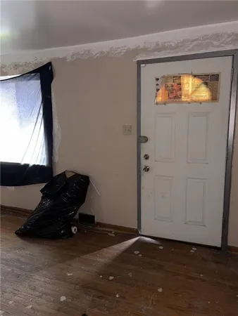 a living room with a bed and a window