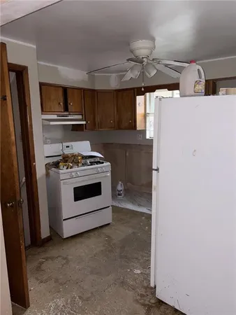 a kitchen with a stove and a refrigerator
