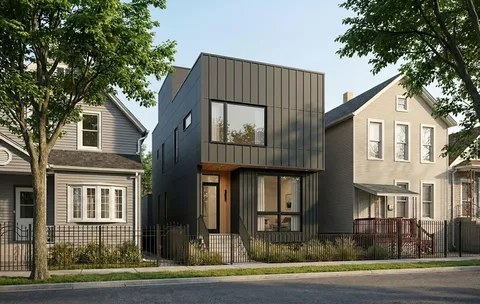 a view of a brick house with large windows and a palm tree