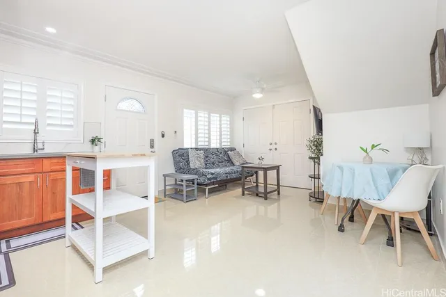 a living room with furniture a clock and a window