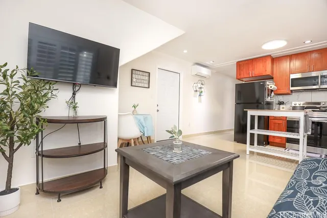 a living room with stainless steel appliances kitchen island granite countertop furniture and a kitchen view