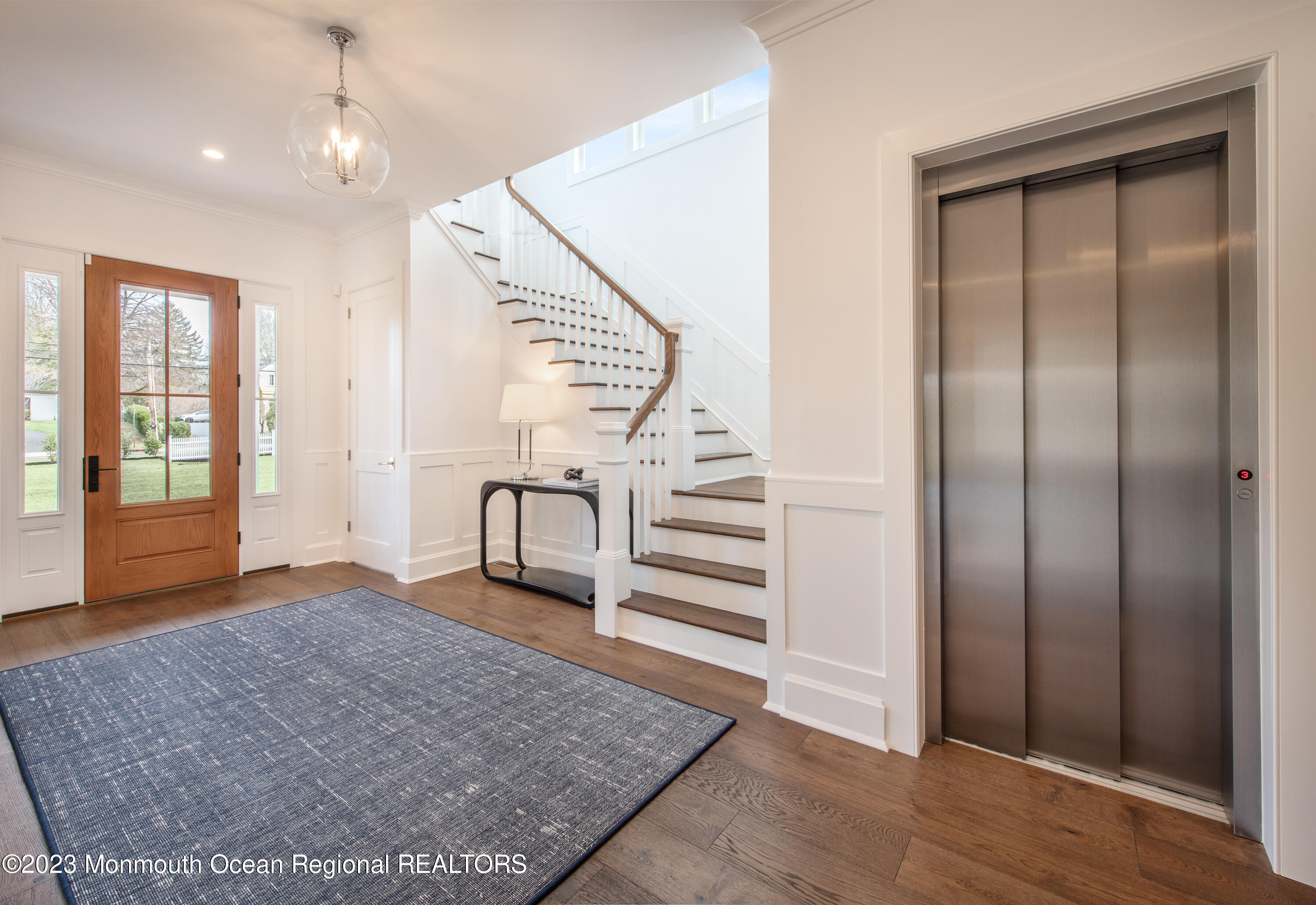 25 Bingham Avenue Rumson, NJ 07760 - Photo 4 of 21 an empty room with wooden floor staircase and windows
