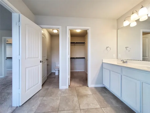 a bathroom with a double vanity sink and a mirror