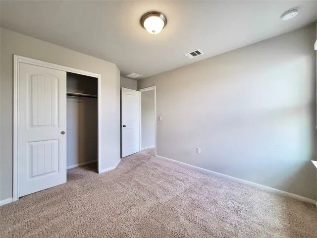 an empty room with closet area