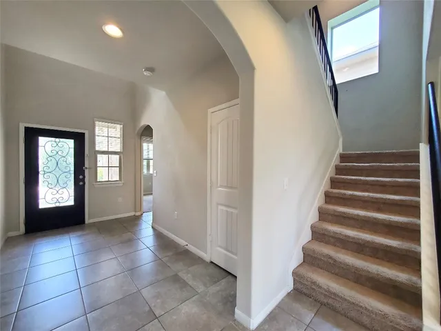 a view of an entryway with wooden floor and a hallway