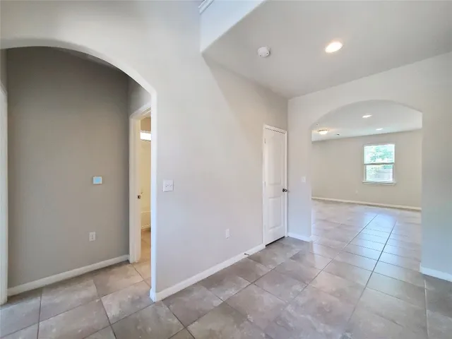 an empty room with windows and entrance