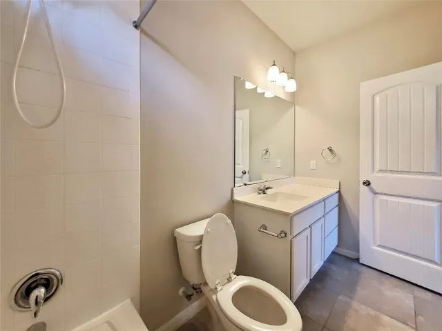 a bathroom with a sink a toilet and vanity