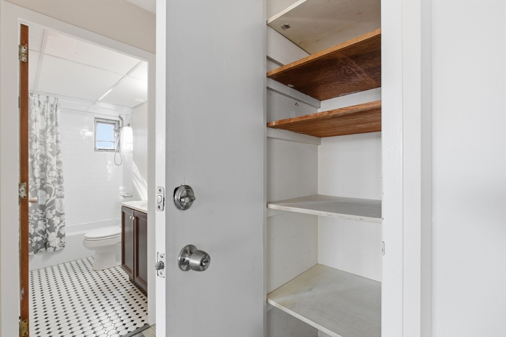 125 Trapelo Road, Unit 21 Belmont, MA 02478 - Photo 14 of 19 a bathroom with a sink and glass door