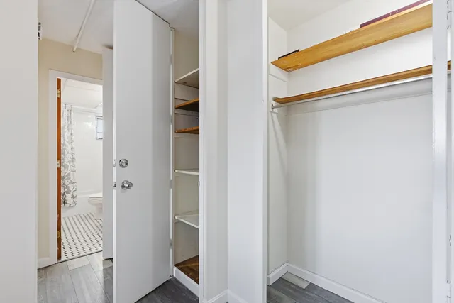a view of an entryway with wooden floor and livingroom view