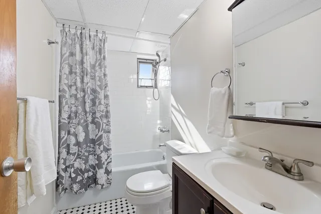 a bathroom with a sink toilet a mirror and shower