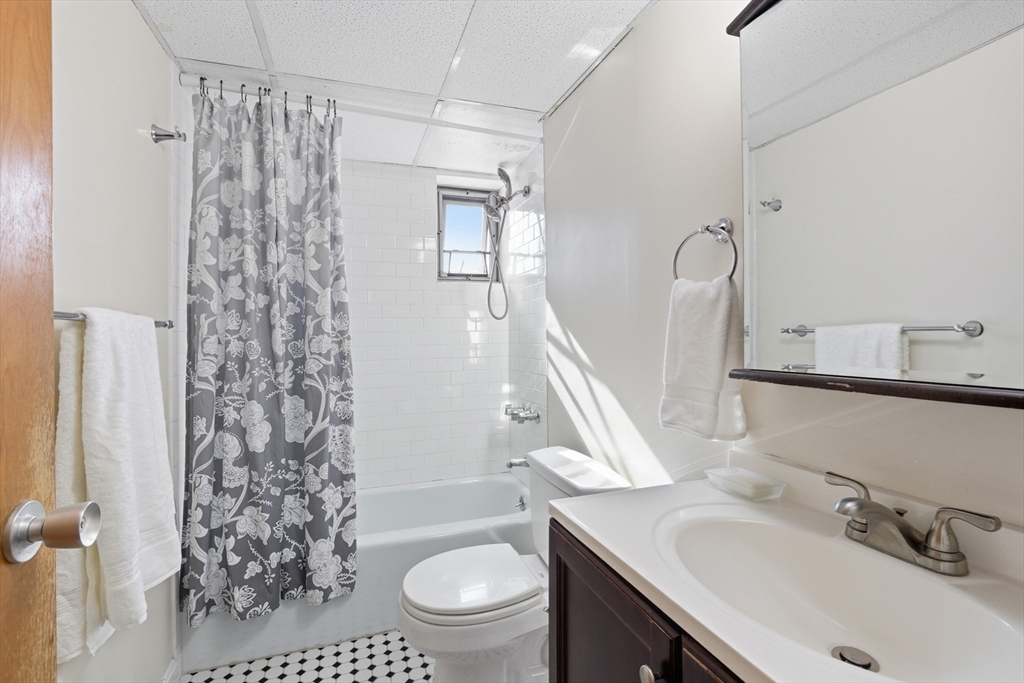 125 Trapelo Road, Unit 21 Belmont, MA 02478 - Photo 3 of 19 a bathroom with a sink toilet a mirror and shower