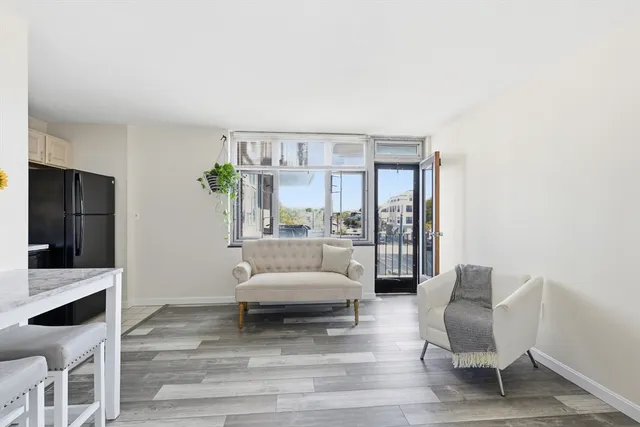 a living room with furniture and a large window