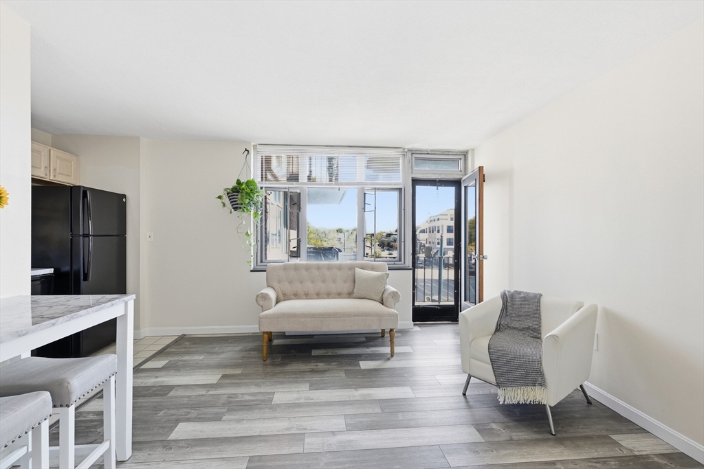 125 Trapelo Road, Unit 21 Belmont, MA 02478 - Photo 6 of 19 a living room with furniture and a large window