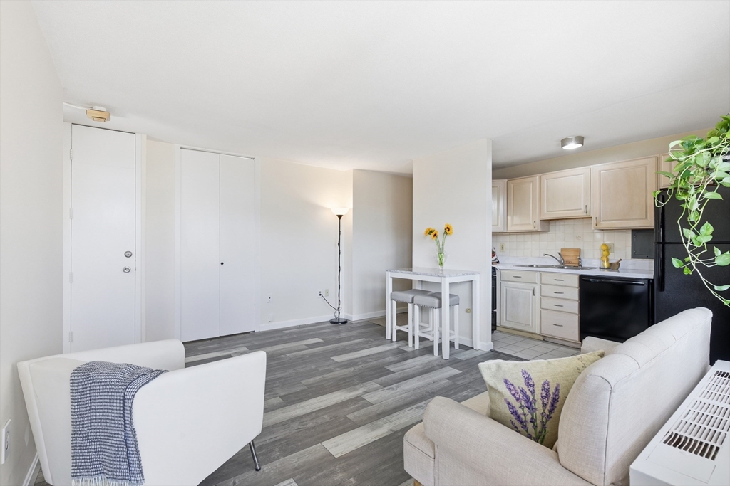 125 Trapelo Road, Unit 21 Belmont, MA 02478 - Photo 7 of 19 a living room with furniture and a view of kitchen