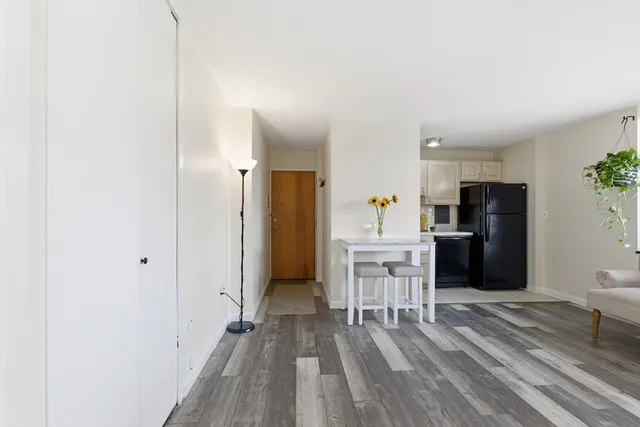 a kitchen with a refrigerator and a table