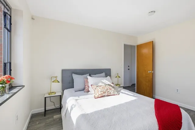 a bedroom with a bed and a window