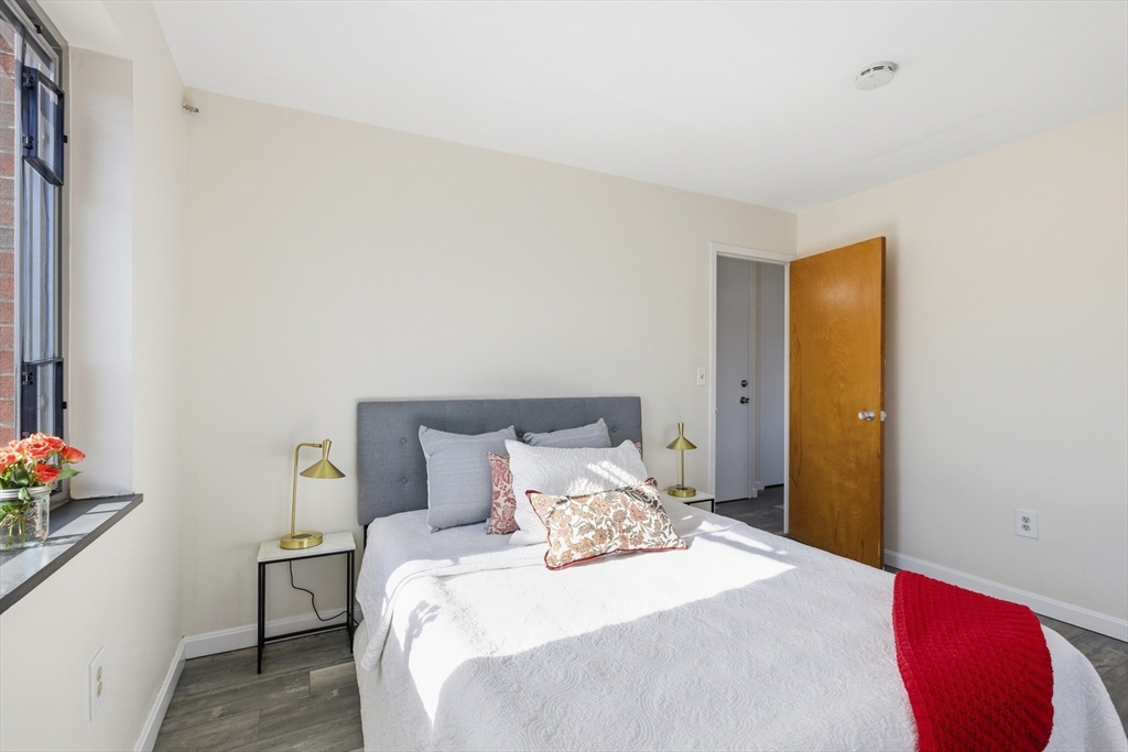 125 Trapelo Road, Unit 21 Belmont, MA 02478 - Photo 10 of 19 a bedroom with a bed and a window