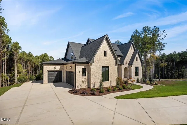 a view of a house with a yard and trees