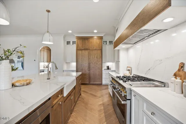 a kitchen with a sink a stove and cabinets