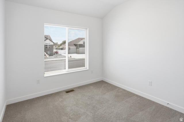 3636 West 910 South Syracuse, UT 84075 - Photo 13 of 70 Bright interior space featuring a large window with blinds, light gray carpet, white baseboards, and white painted walls