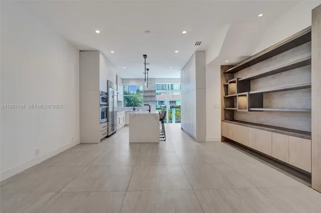 a kitchen with a sink and large window