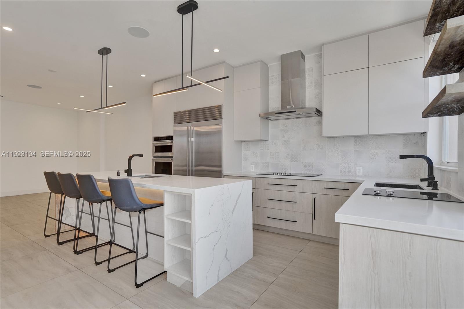 3757 Northeast 208th Terrace Aventura, FL 33180 - Photo 16 of 74 a kitchen with a stove a sink and a refrigerator